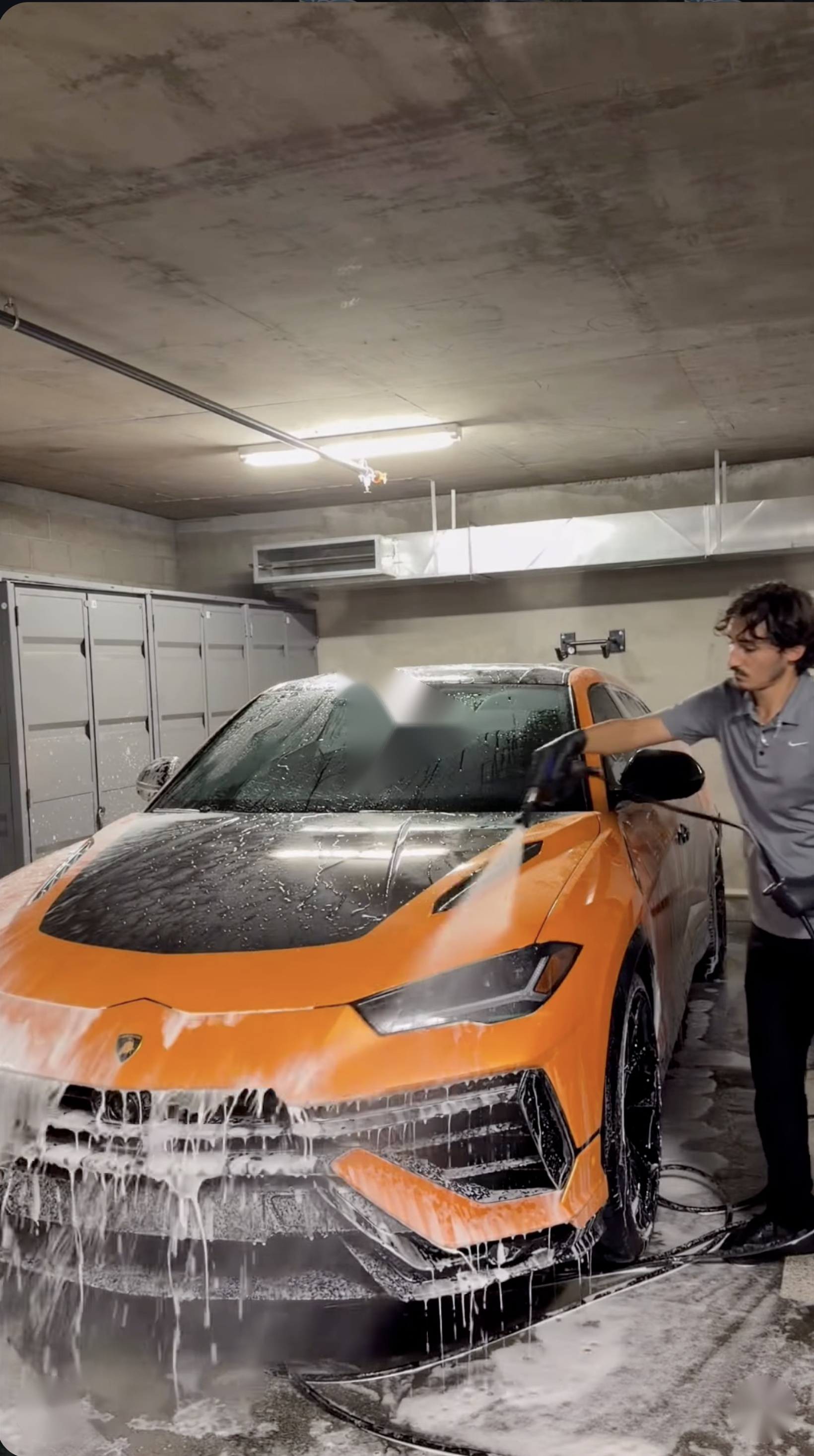 Lifeline Auto Detailing specialist performing high-pressure foam wash on an orange Lamborghini Urus