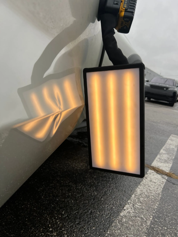 PDR reflection light positioned against the white vehicle during inspection