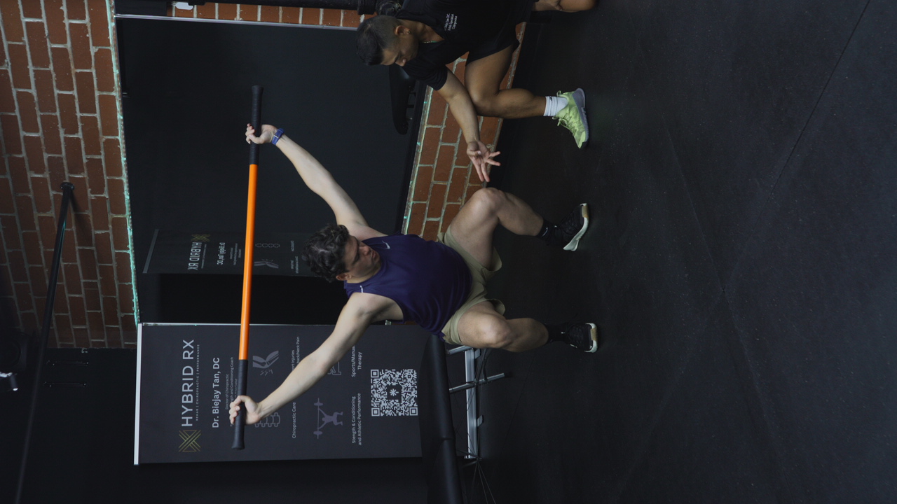 Dr. Biejay Tan coaching an overhead mobility assessment at HYBRID RX