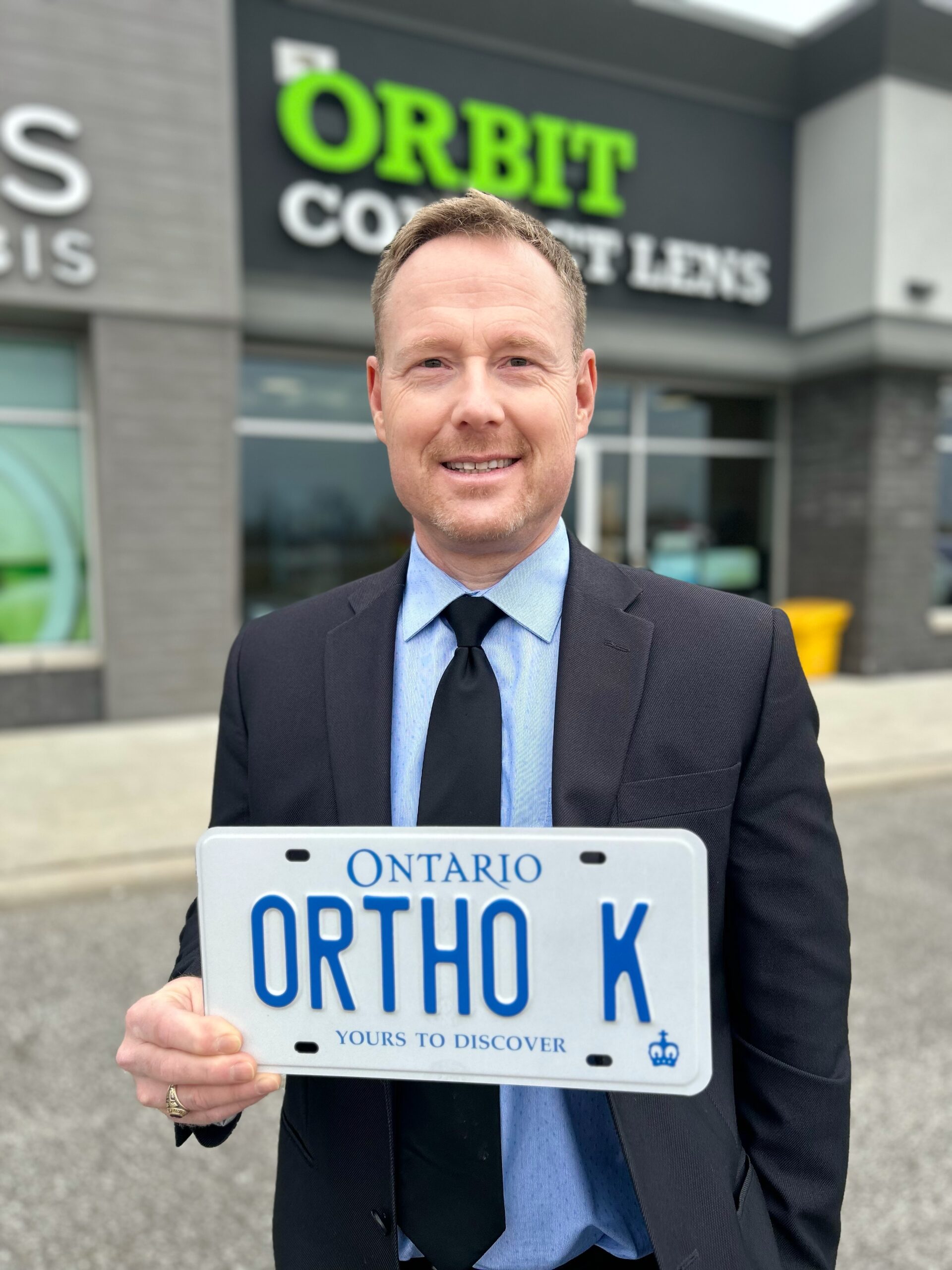 Jason holding Ontario ORTHO K plate outside Orbit Contact Lens