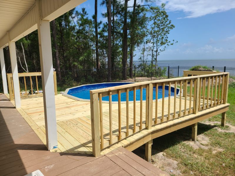 Sunlit Pool Deck Overlooking the Bay by Protech Decks in Coden / Belle Fontaine