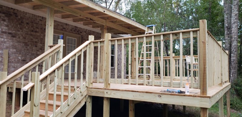 Covered back deck with precision stair framing and structural through-bolted railing posts