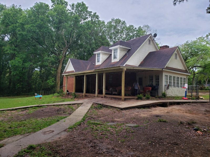 Full-length covered porch addition providing continuous shade and weather protection
