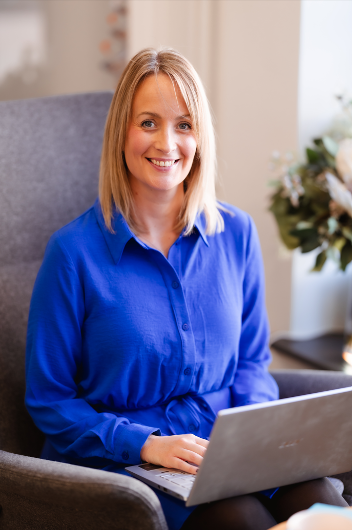 Kat Maynard, occupational psychologist, holding a laptop