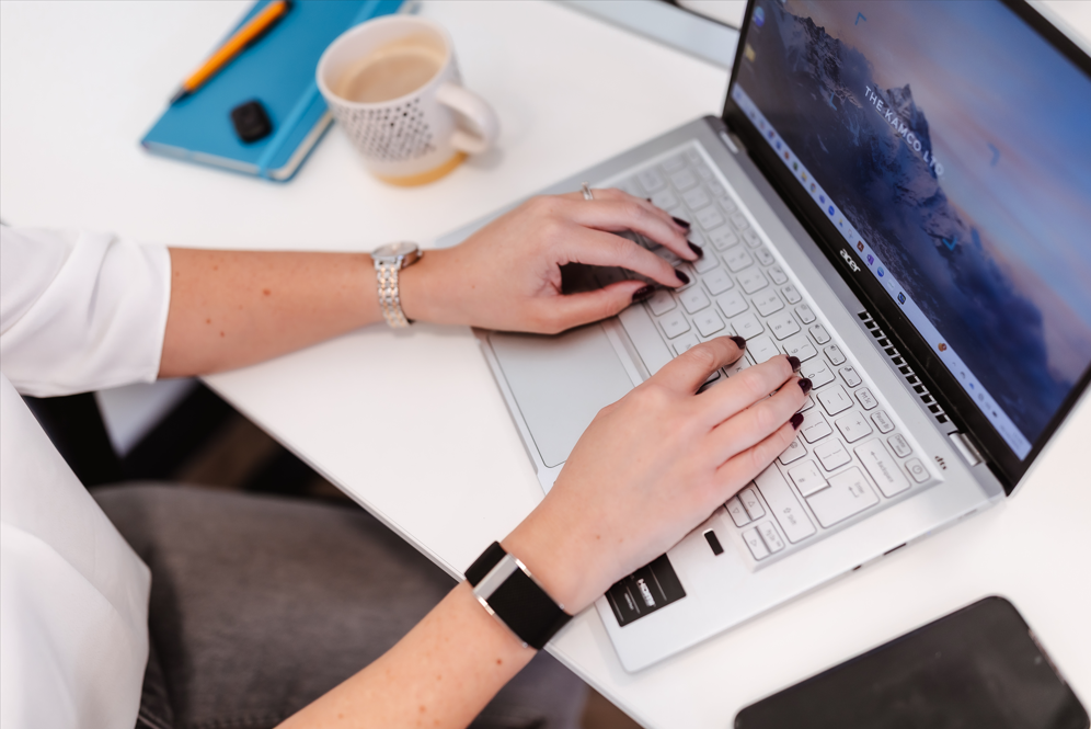 Reviewing leadership reflections and working on a laptop