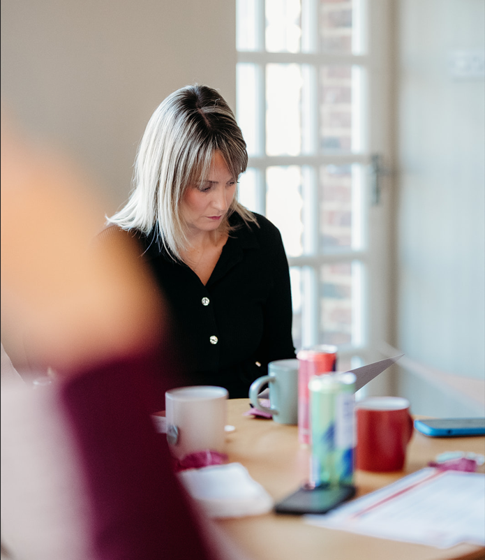 Kat Maynard reviewing leadership materials in a workshop setting