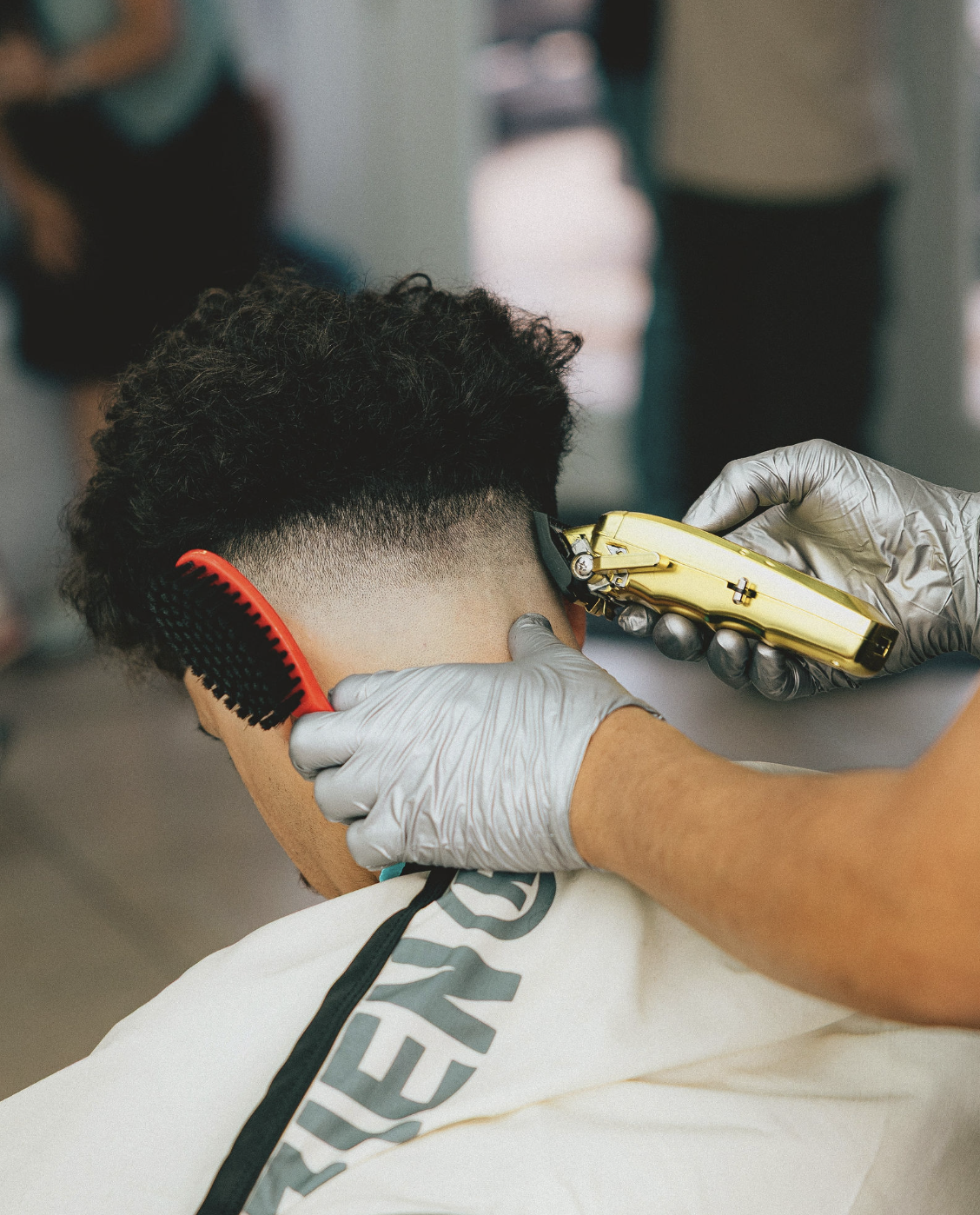Precision taper fade with gold clippers at 22nd Street Barber Lounge