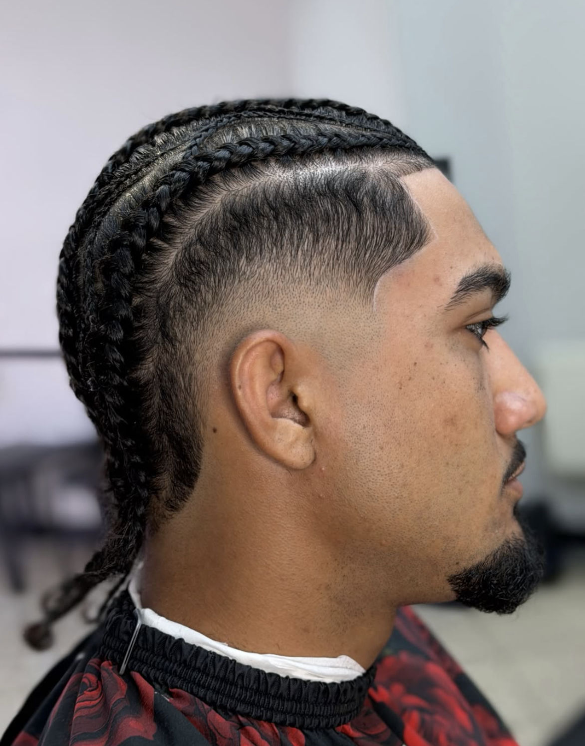 Clean braids with temple taper fade and razor edge up