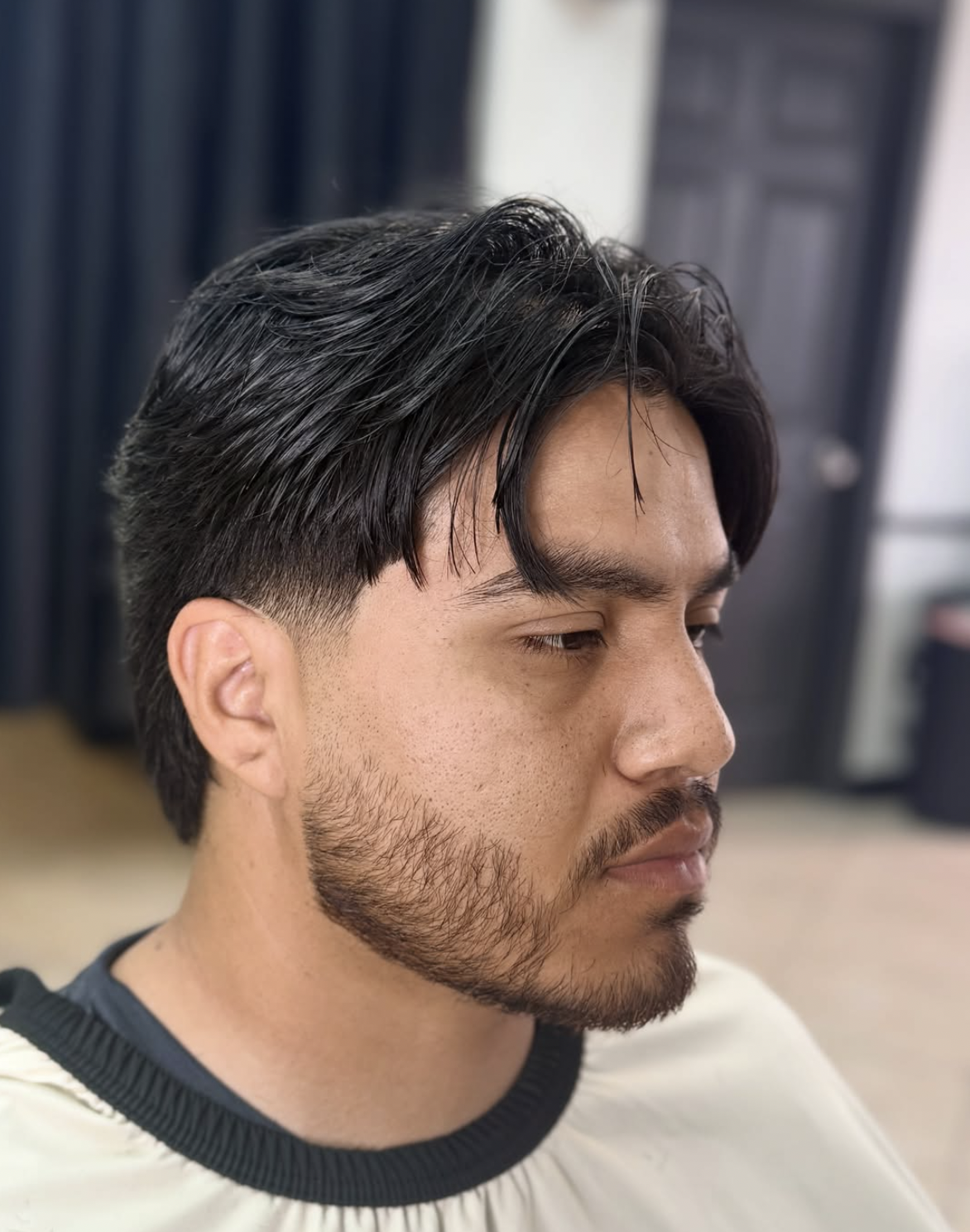 Gentleman's flow cut, clean side taper, and sculpted beard