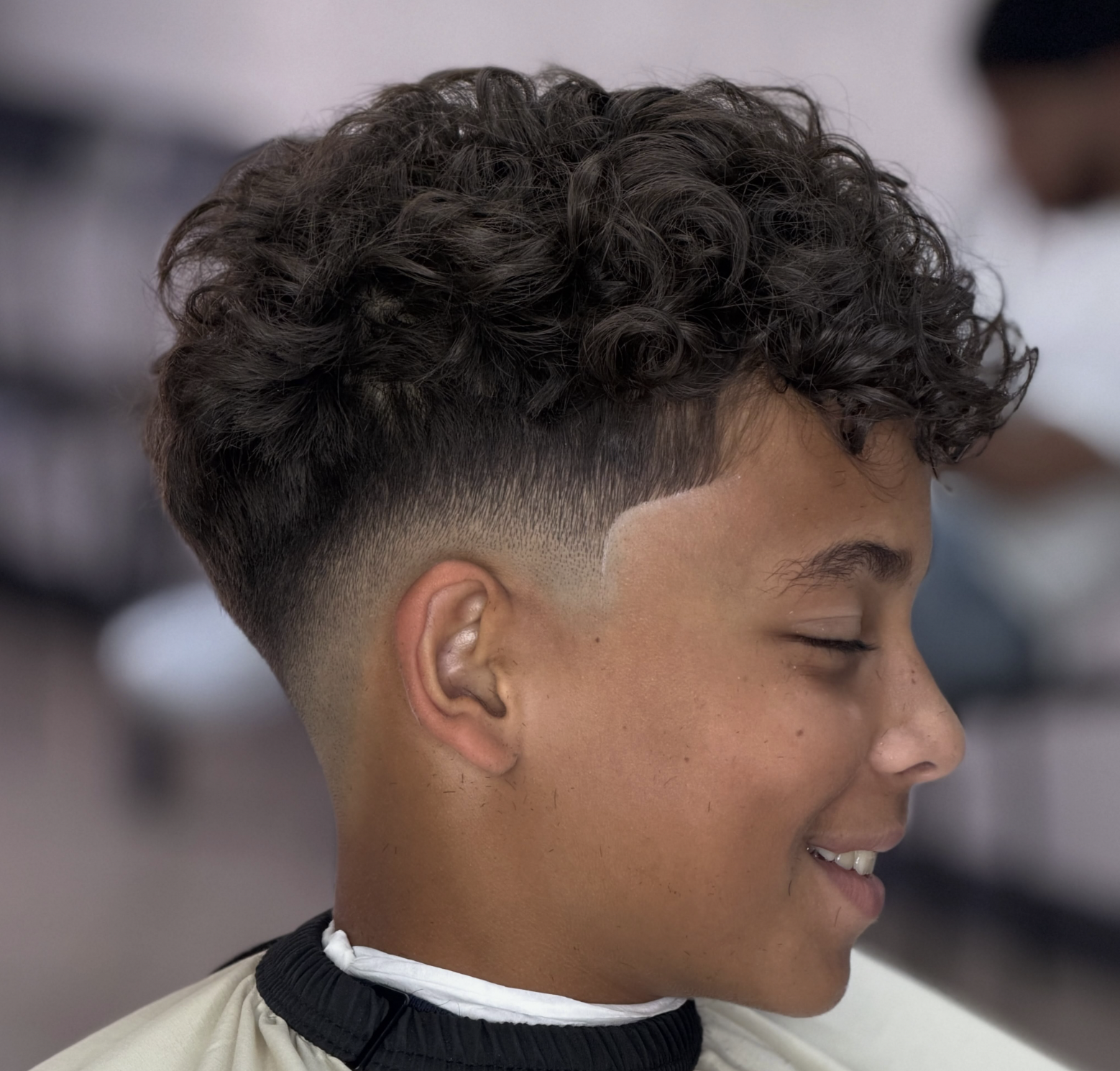 Clean curls taper fade cut at 22nd Street Barber Lounge