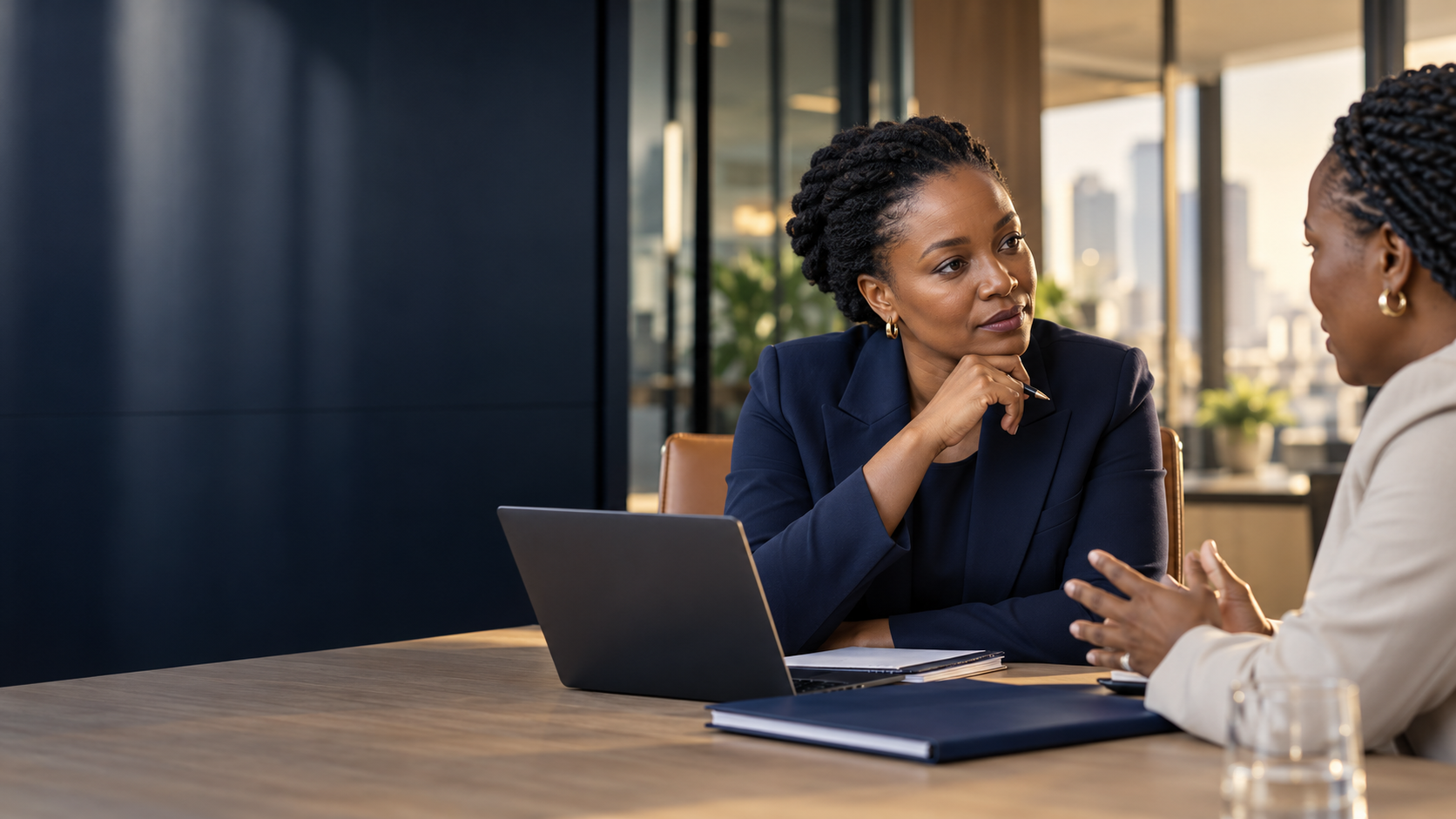 South African legal adviser consulting with a client at a contemporary conference table