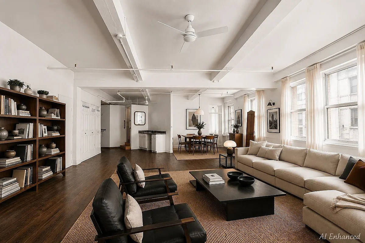 Open-concept great room looking across living and dining areas toward custom library millwork