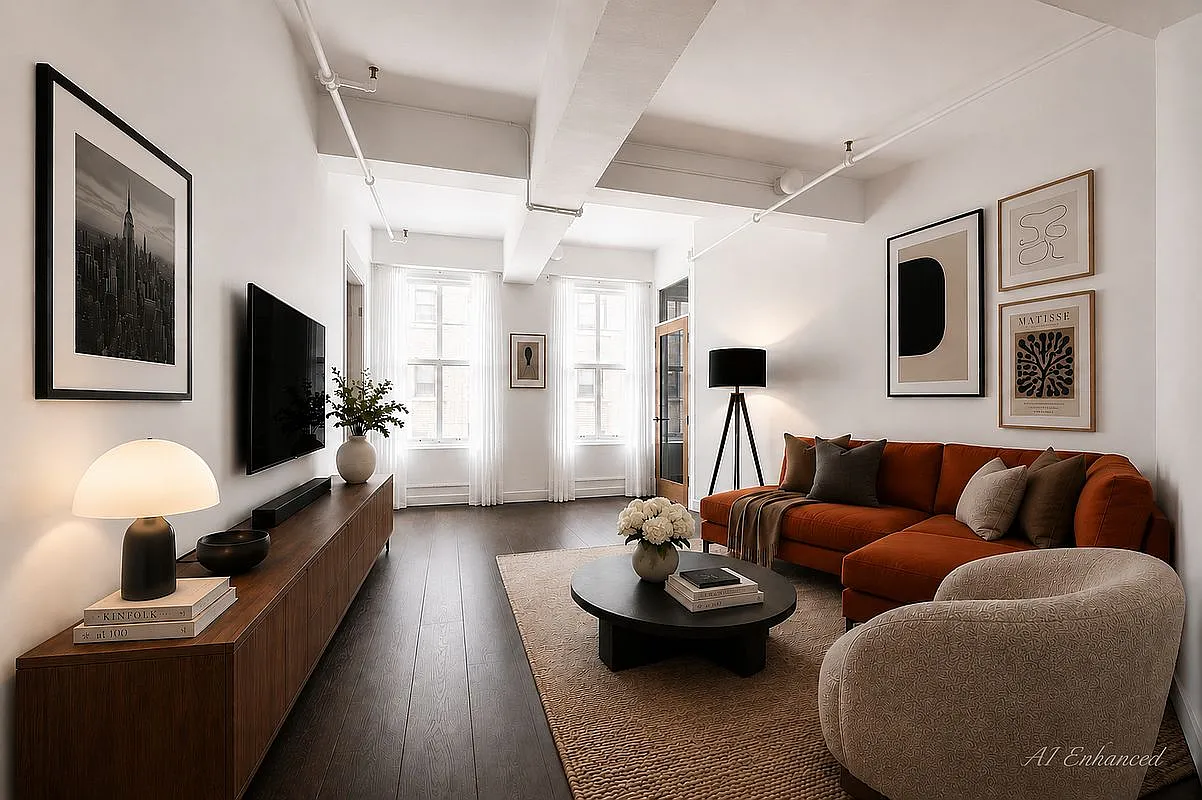 Staged media lounge with burnt-orange sectional sofa, custom walnut console and city windows