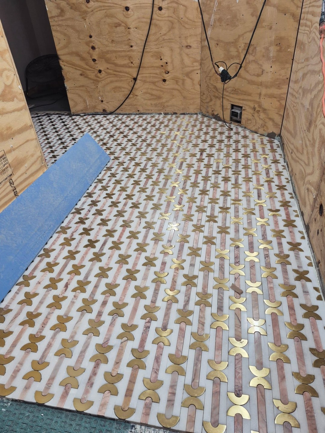 Close-up of a custom stone feature wall with soft marble veining and minimal seams