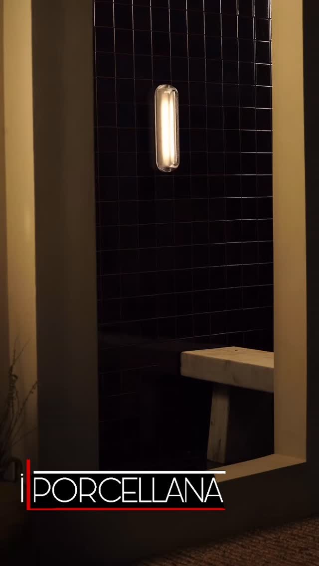 Modern luxury residential steam shower with floor-to-ceiling tile, a built-in bench, and a frameless glass enclosure