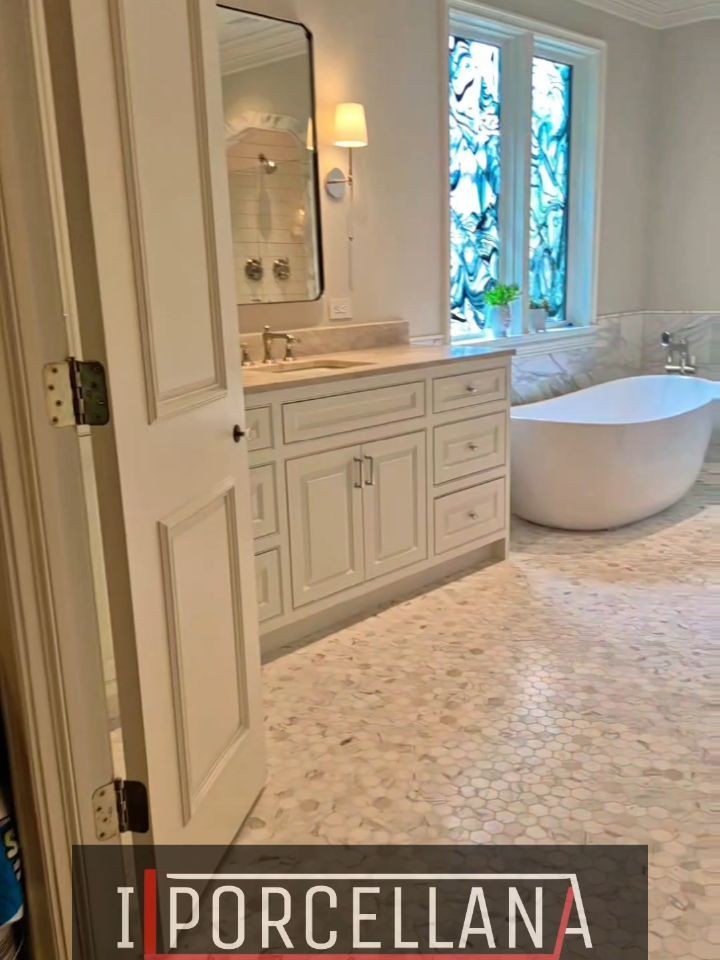 Shower interior with floor-to-ceiling tile, a built-in niche, and a stone bench