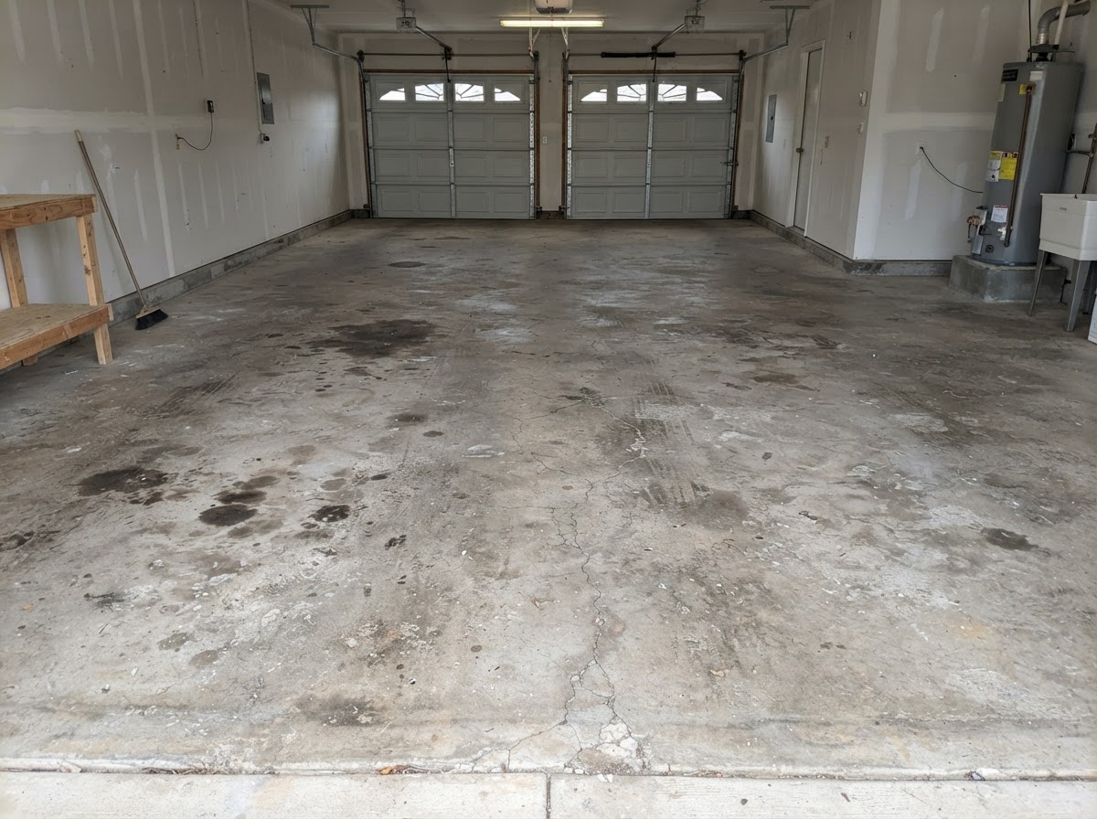 Bare stained garage concrete floor before coating