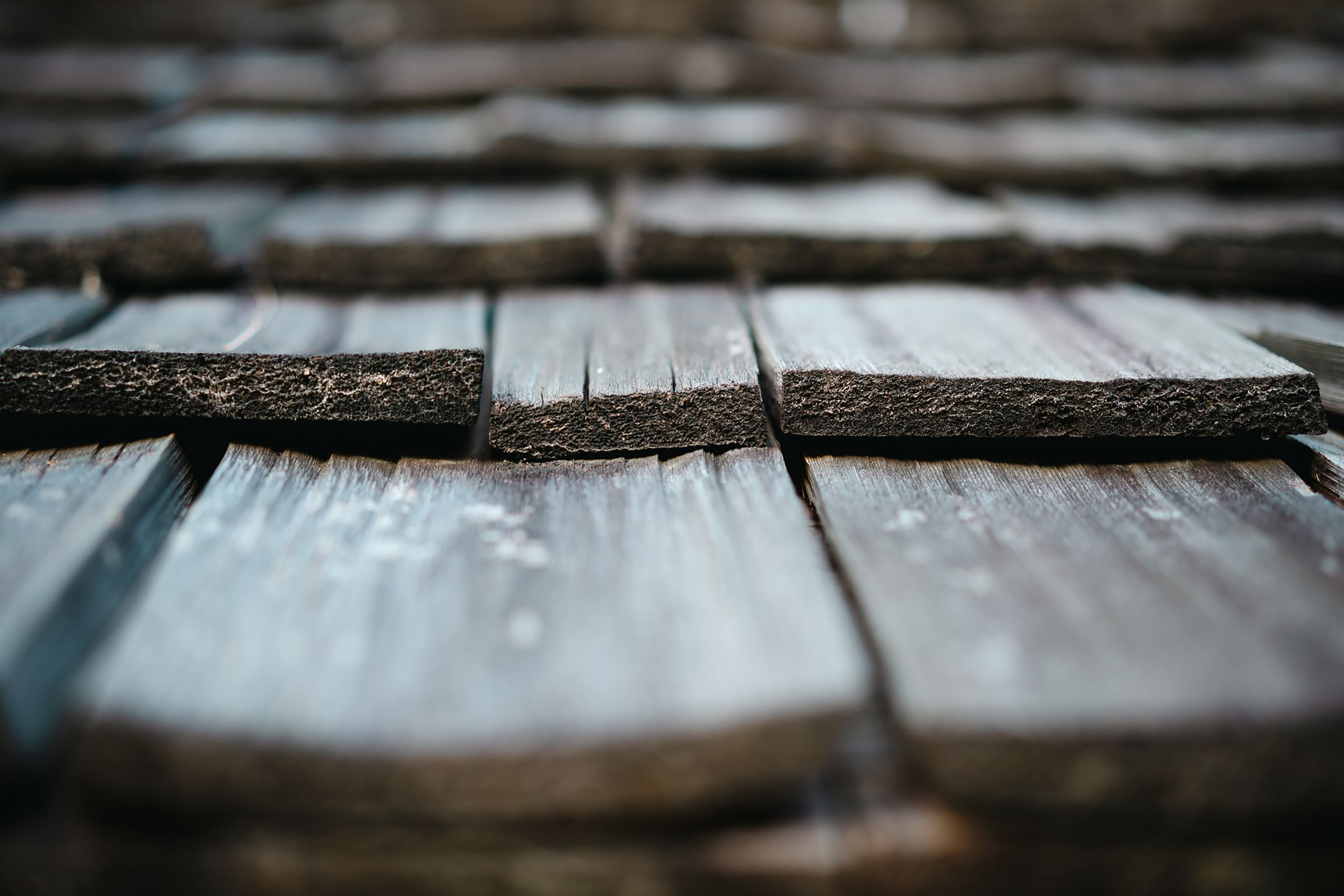 Close-up of a cracked and split wooden shake shingle