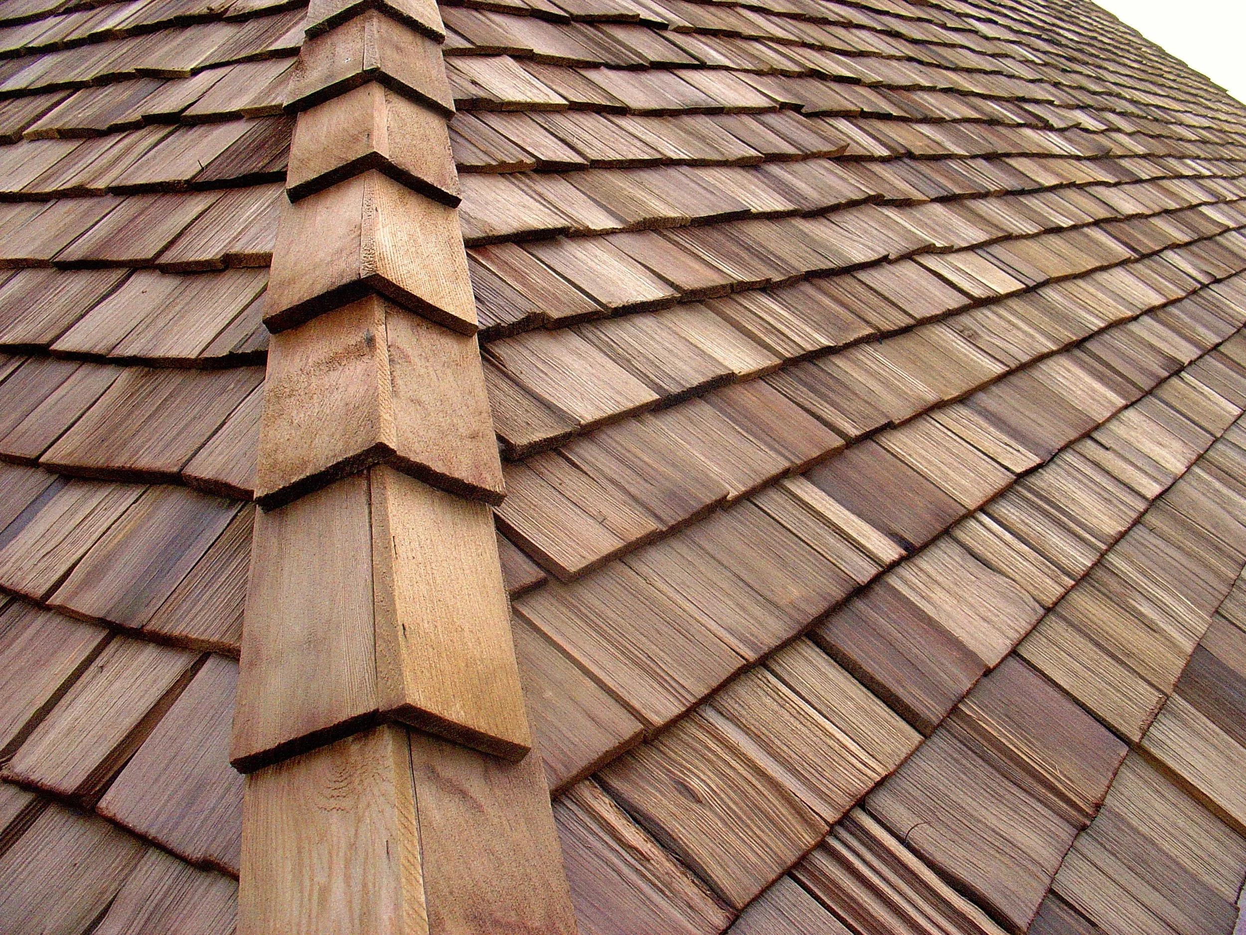 Close-up of authentic cedar shake roof with visible ridge and grain detail