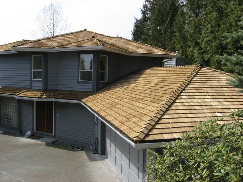 Finished golden cedar roof showcasing ridge and shake restoration detail