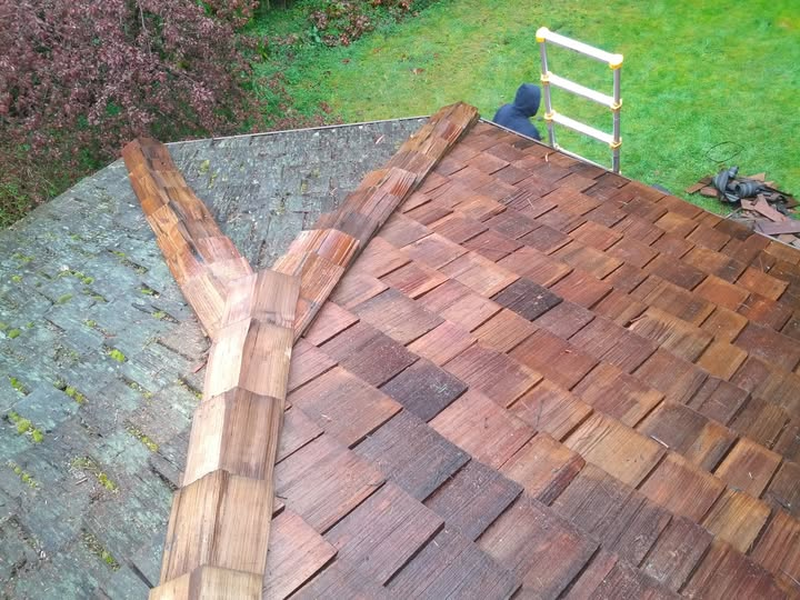 Cedar roof repair showing shake ridge work in progress