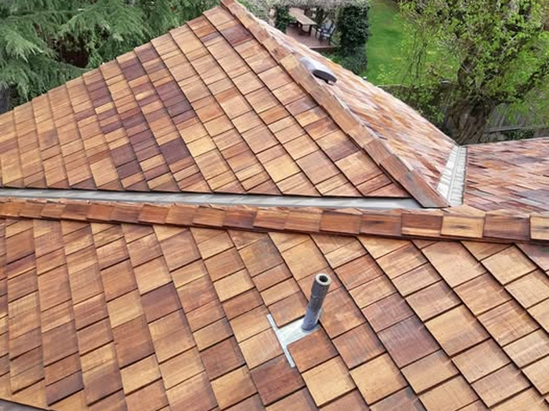 Cedar shingles around roof vent illustrating roof condition and maintenance