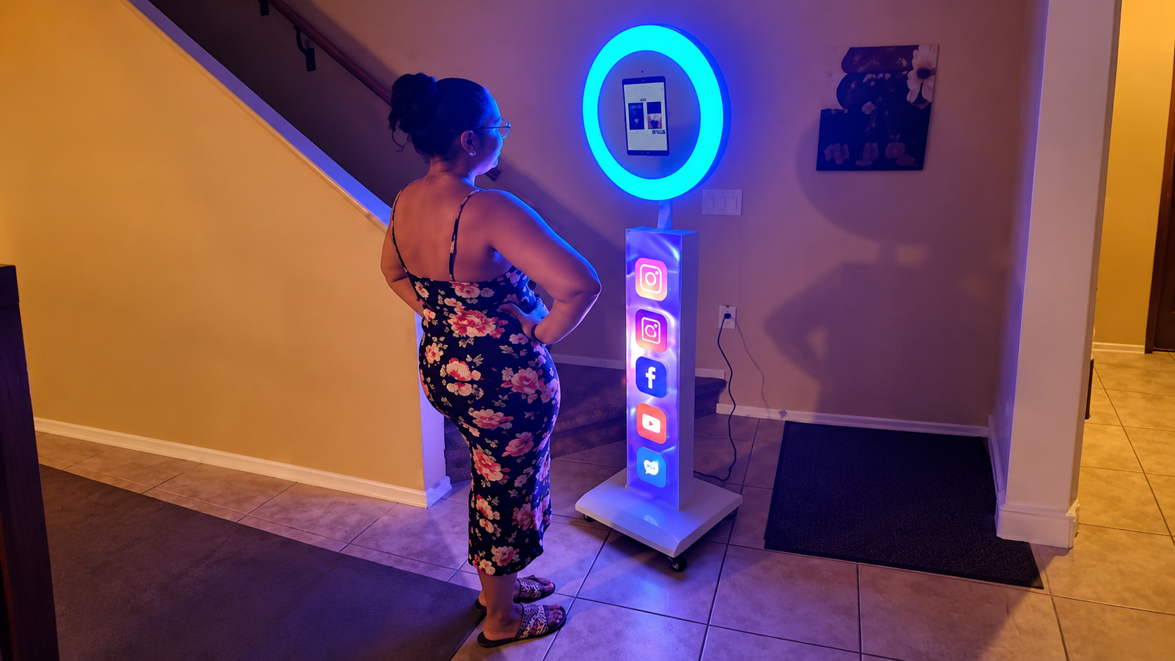 Sleek glowing digital photo booth kiosk with social sharing options