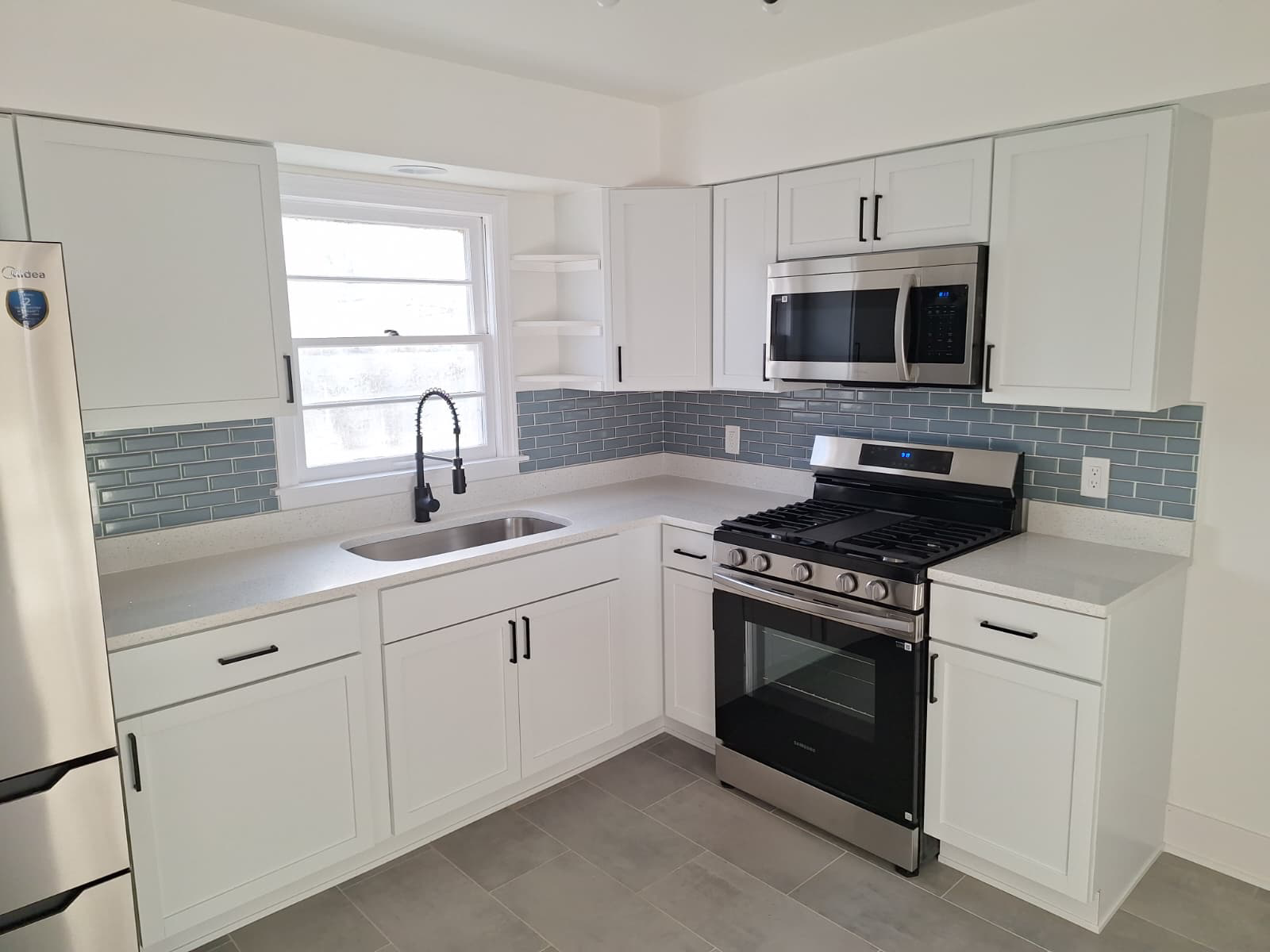 Modern kitchen remodel with blue subway tile