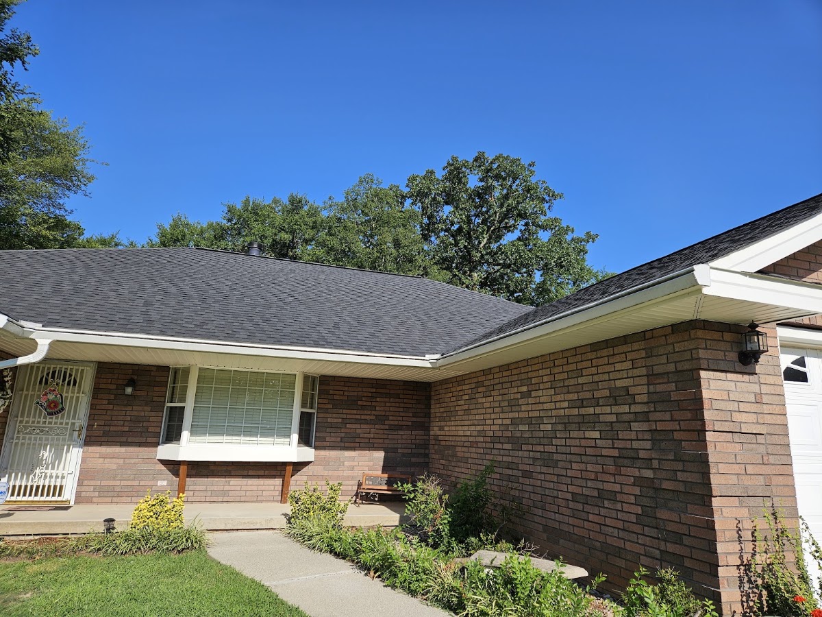 New hand-nailed shingle roof installed on a brick home by Razorback Construction