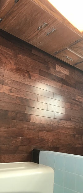 Wood look bathroom floor installed by American Flooring LLC
