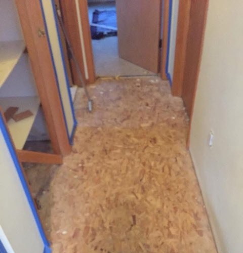 Subfloor prepped and taped off before a new floor installation by American Flooring LLC
