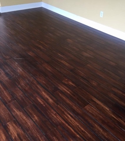 Dark plank living room floor installed by American Flooring LLC