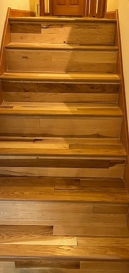 Hardwood stair treads and risers installed by American Flooring LLC