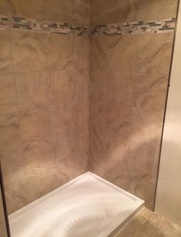 Tile shower surround with glass mosaic accent installed by American Flooring LLC near Madison, WI