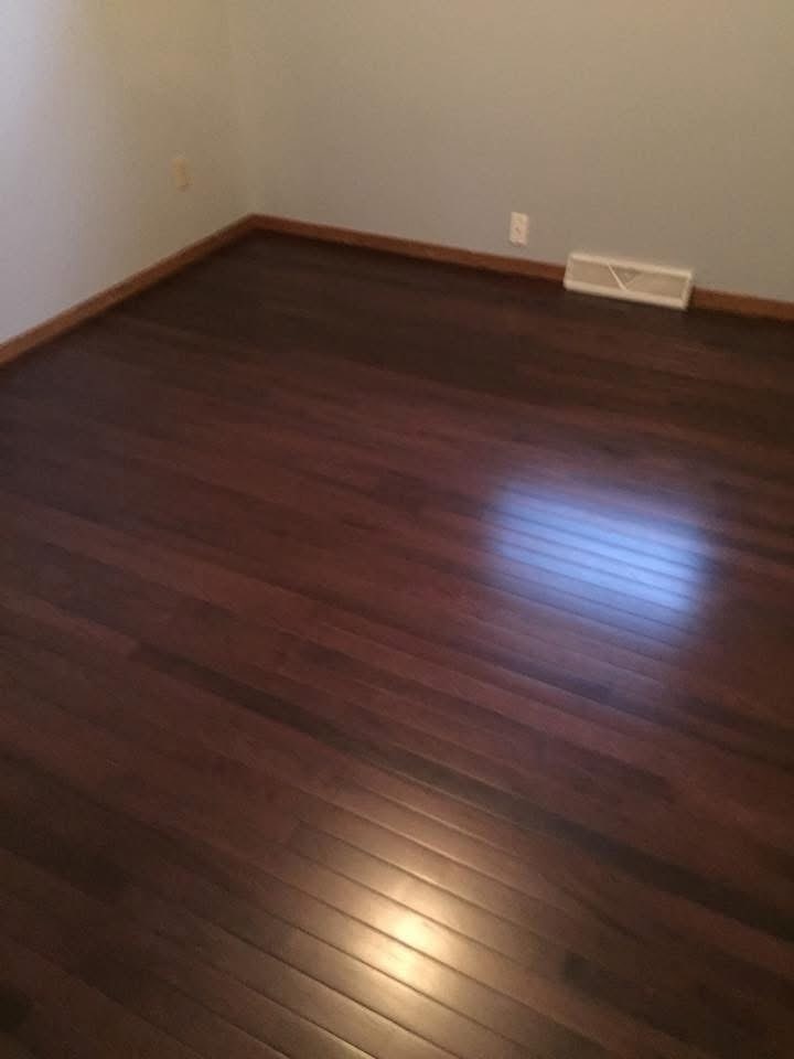Dark hardwood bedroom floor installed by American Flooring LLC near Madison, WI
