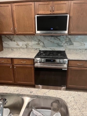 Marble look backsplash behind a range, installed by American Flooring LLC near Madison, WI