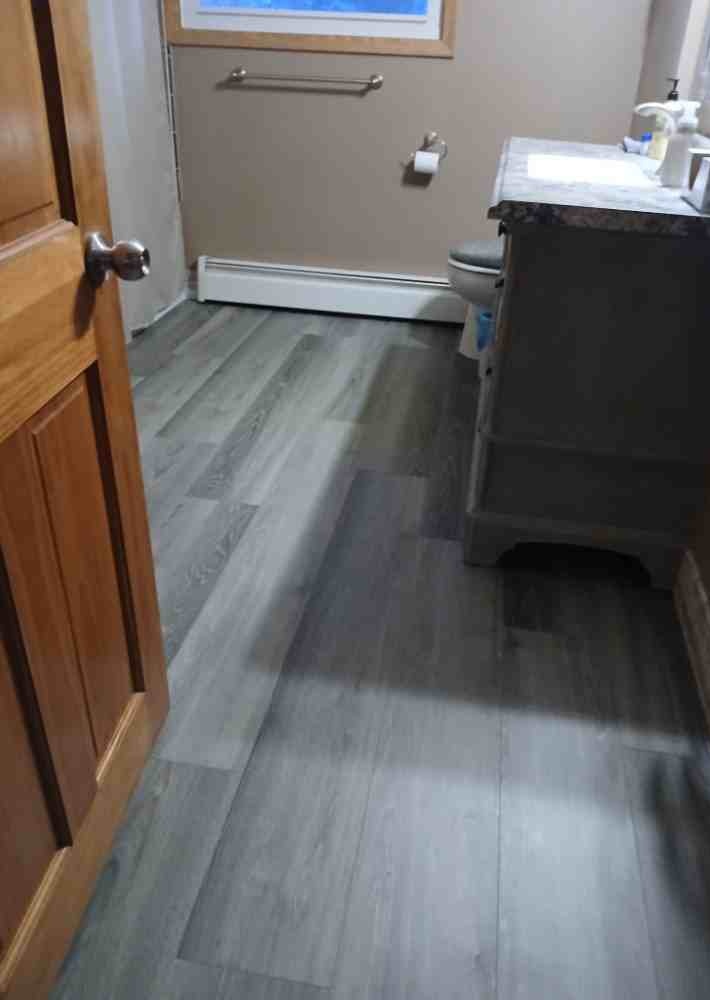 Gray luxury vinyl plank bathroom floor installed by American Flooring LLC in the Sun Prairie, WI area