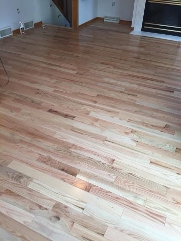 Light natural hardwood living room floor installed by American Flooring LLC in the Sun Prairie, WI area