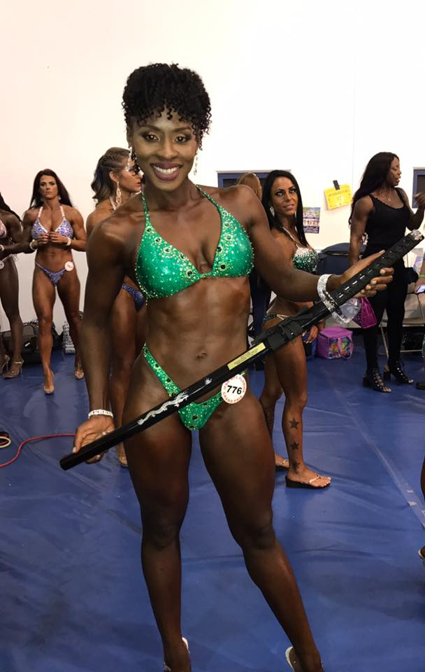 Alecia Monroe 3rd place novice competitor in green suit backstage