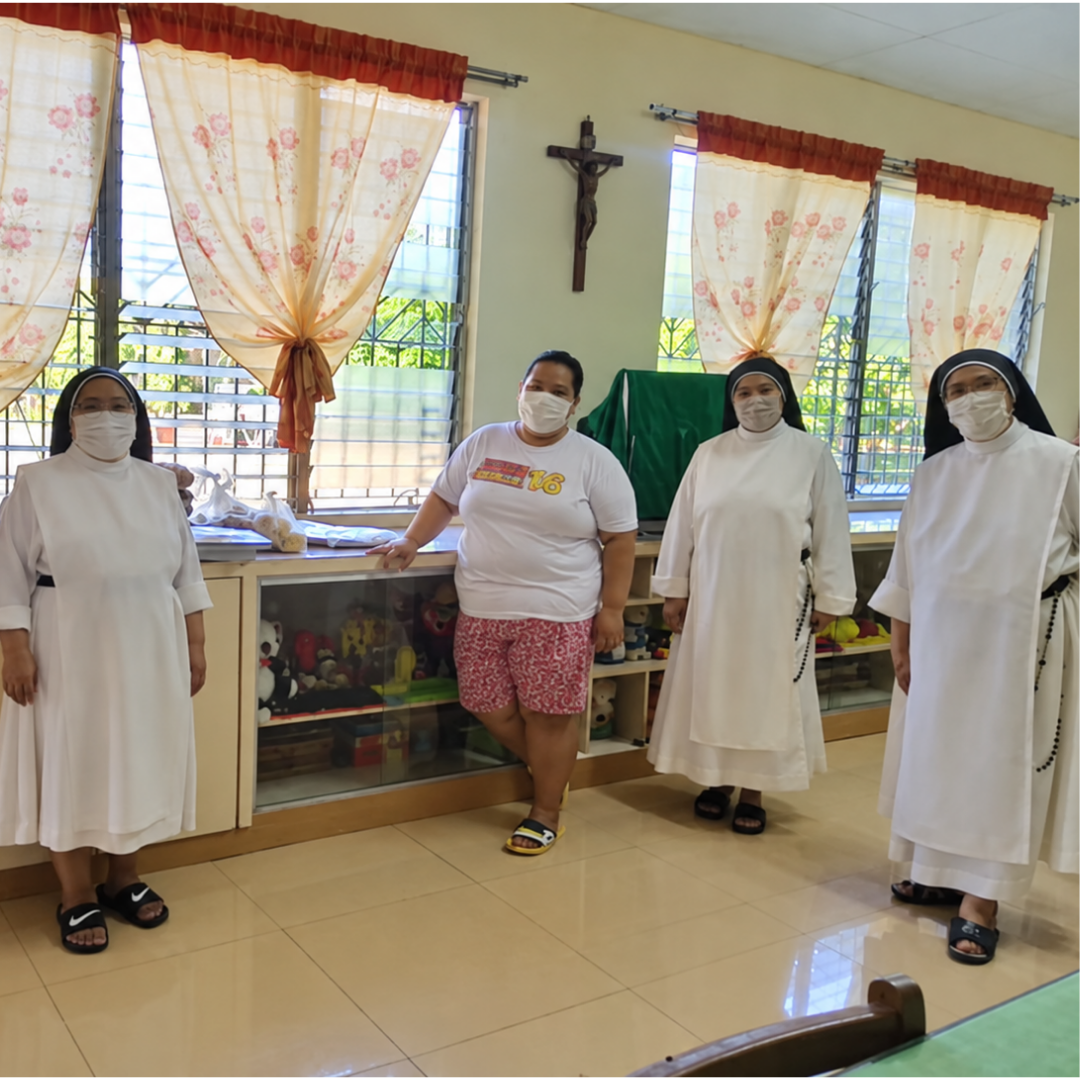 Sisters and community members gathered in the activity room at Omura Homes.