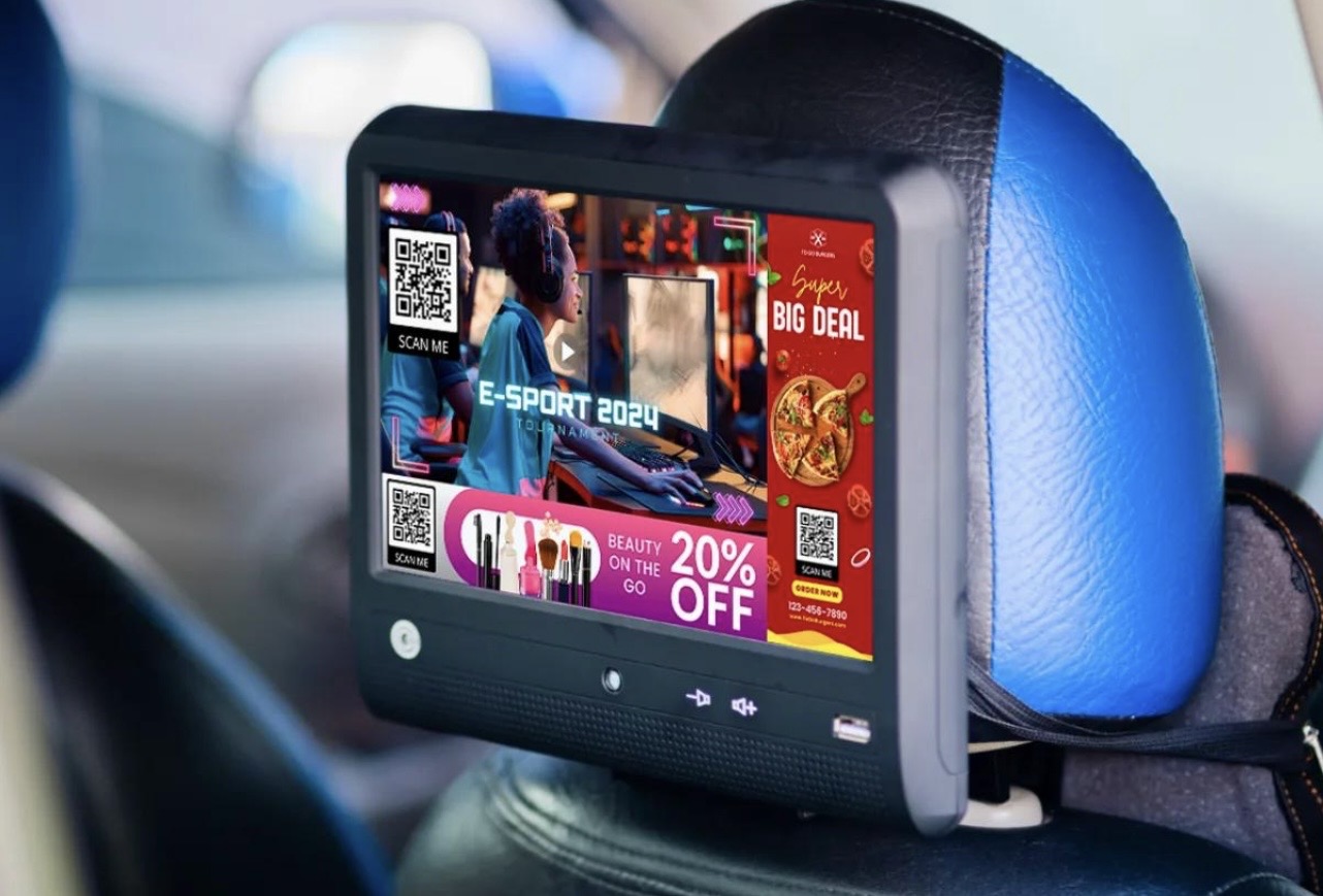 Passenger seatback mounted interactive digital screen in rideshare vehicle displaying local business ads and QR codes