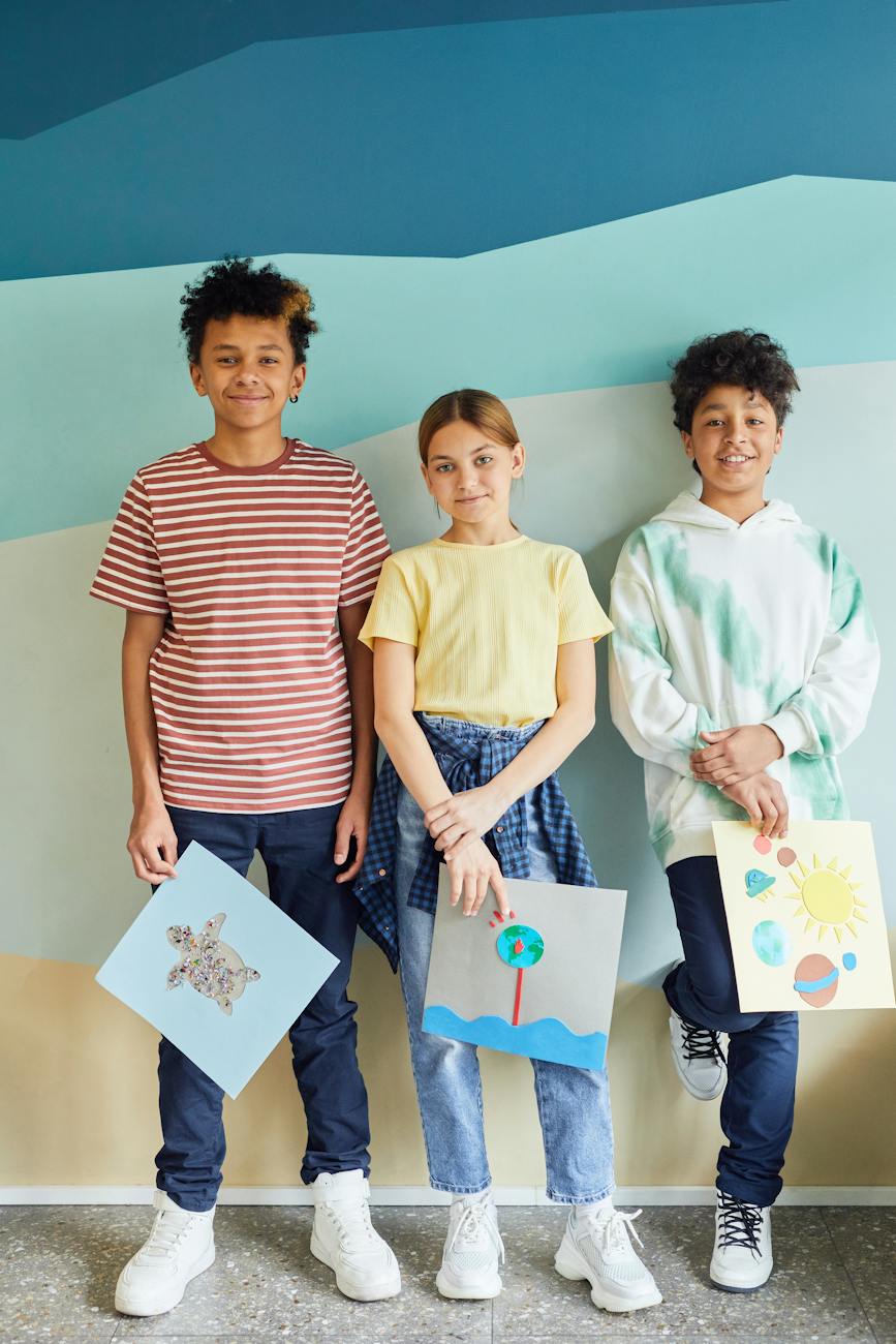 Students holding art projects - supporting school and adolescent growth