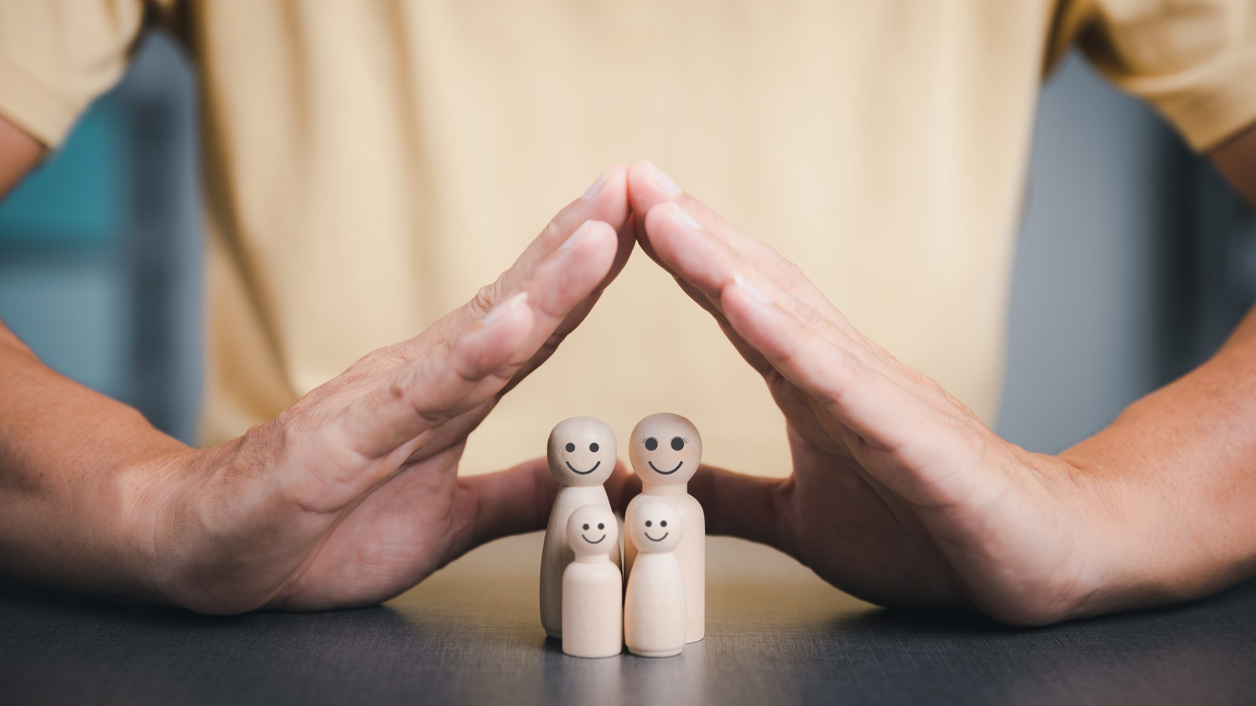 Family hand next to wooden blocks - parenting and life transitions