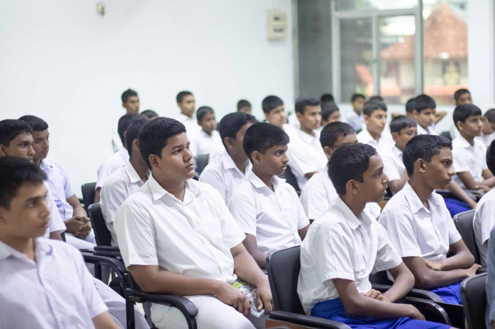 Students seated in the hall attentively following the audio workshop lecture