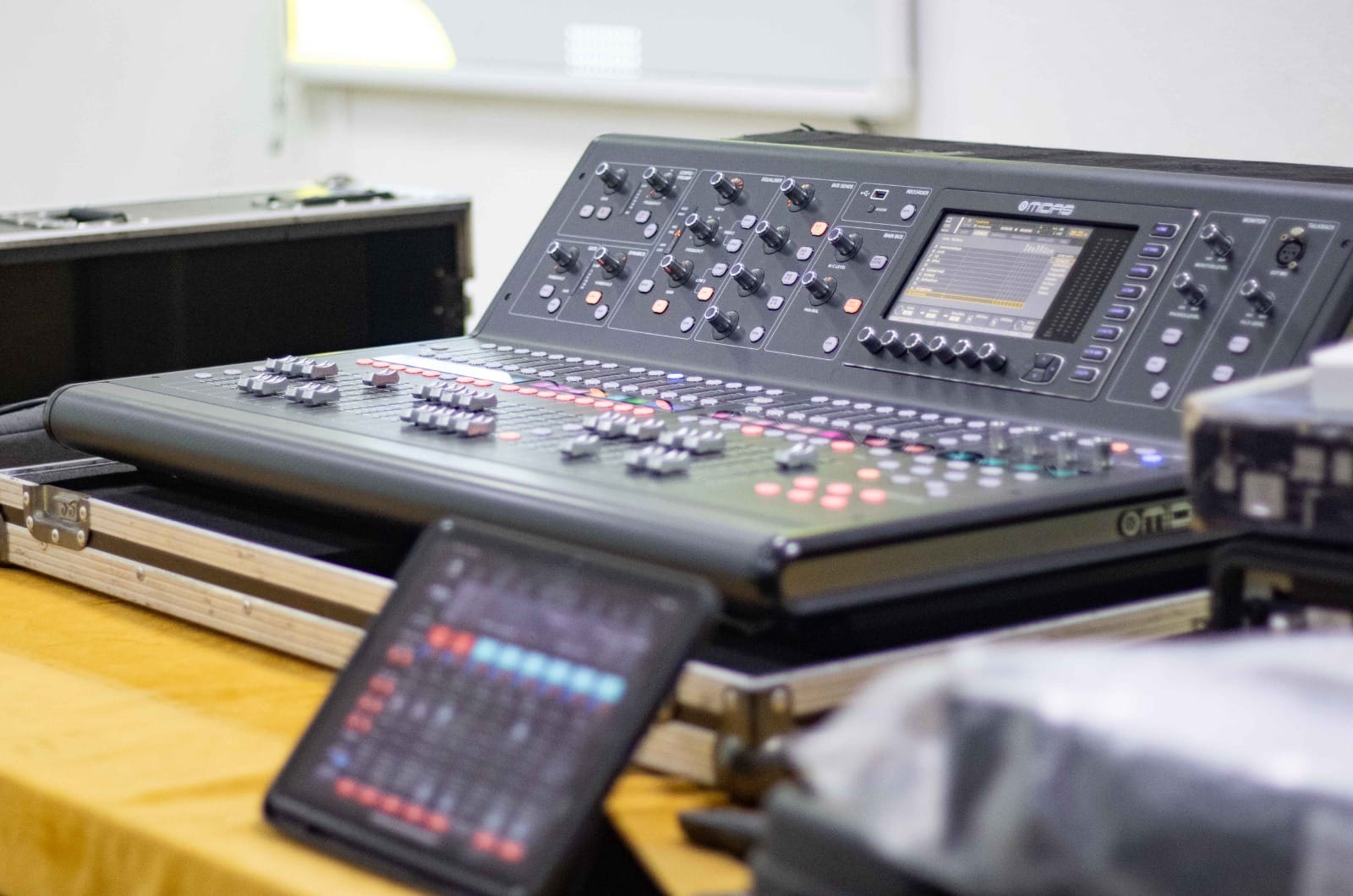Close-up of a digital audio mixing desk with tablet monitor set up for the workshop
