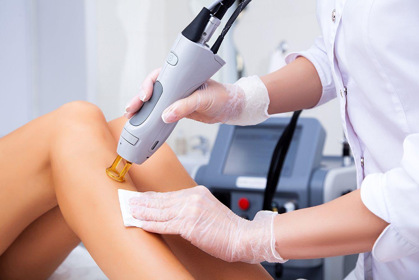 Candela laser treatment in progress using authentic handpiece at Luminous Laser and Skin Spa.