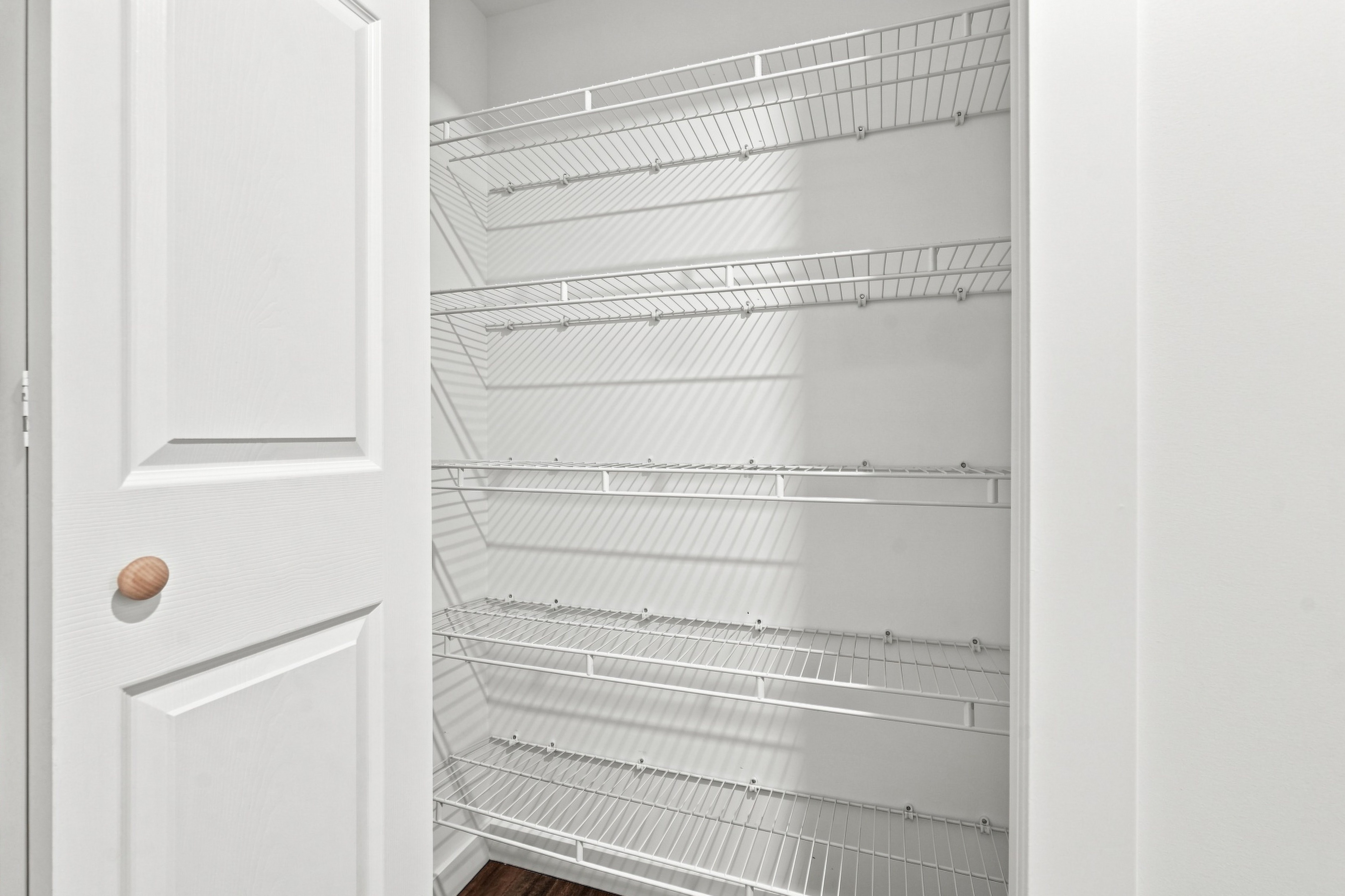 Walk-in linen and pantry closet with five deep wire shelves