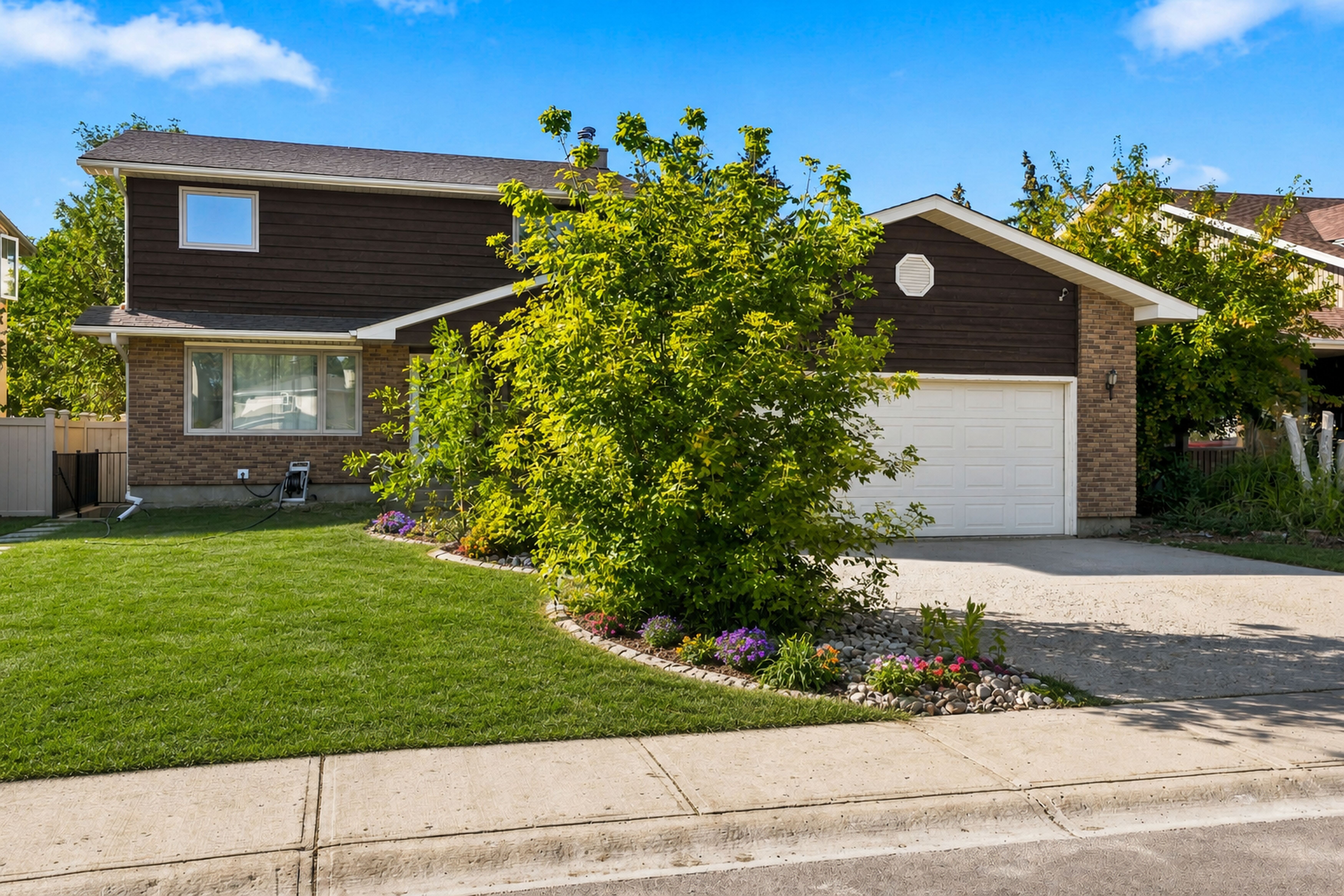 Front exterior showing quiet residential Wascana View street and driveway