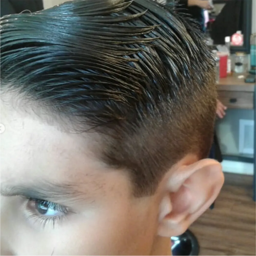 Young Warrior Gloss Comb-Over Fade by barber at Spartan Baracks in East York Toronto