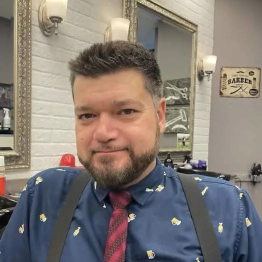 Aggie master barber and founder at Spartan Baracks barbershop East York Toronto